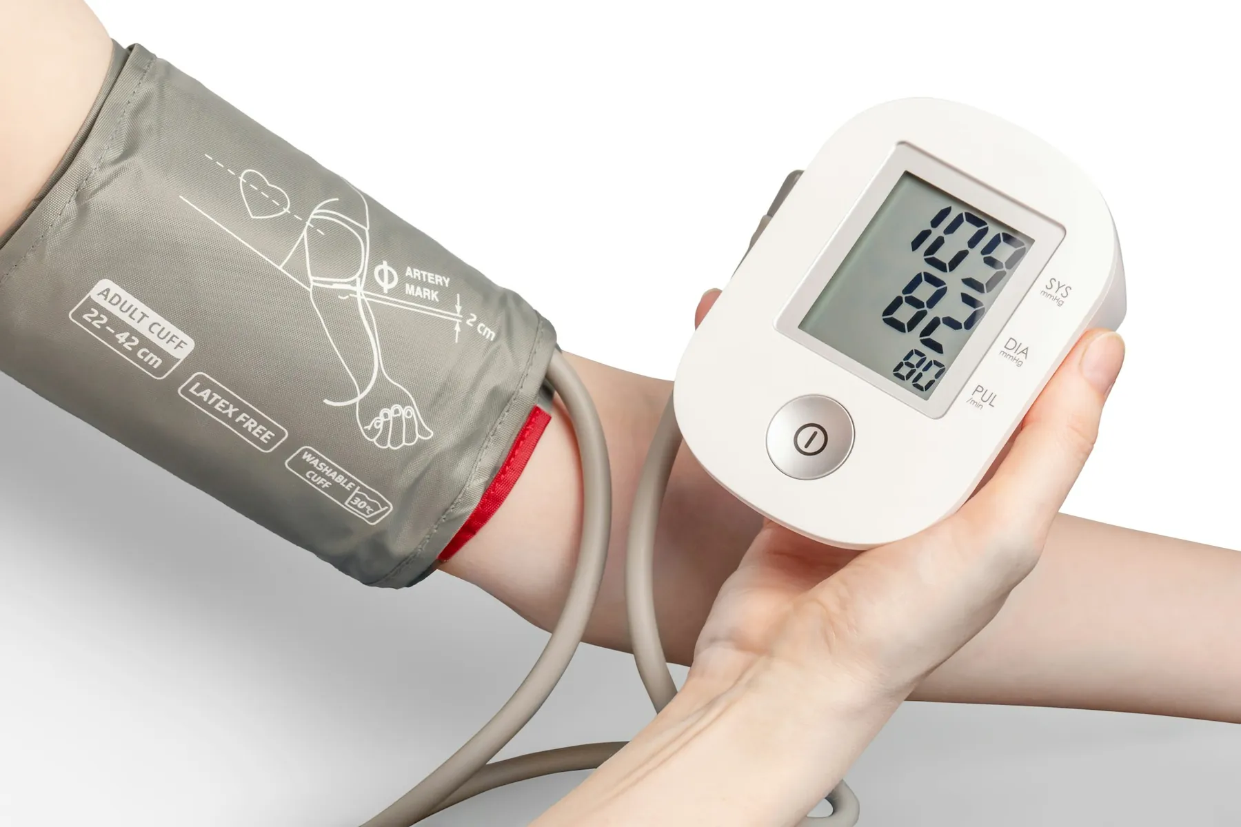 A blood pressure cuff and digital monitor on an arm
